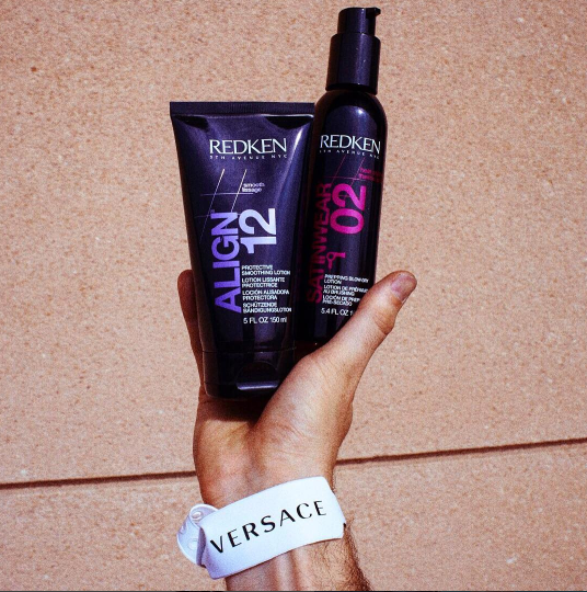 Redken Align 12 and Satinwear 02 being held up by a hand